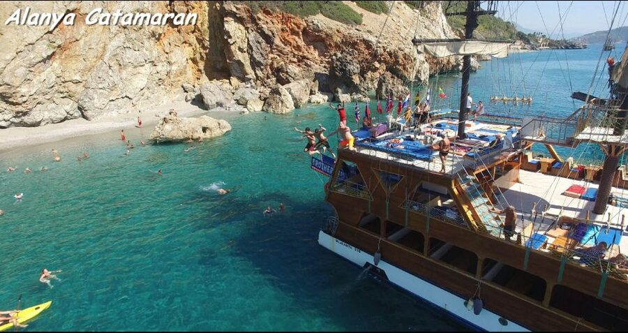 Alanya: Catamaran Boat Trip with Swim Stops and Sunbathing - Setting off from Alanya Harbor near the Red Tower