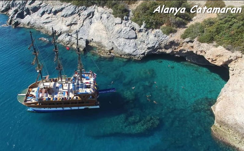 Alanya: Catamaran Boat Trip with Swimming Stops incl Lunch - Leaving Alanya Harbor with the Castle Ahead