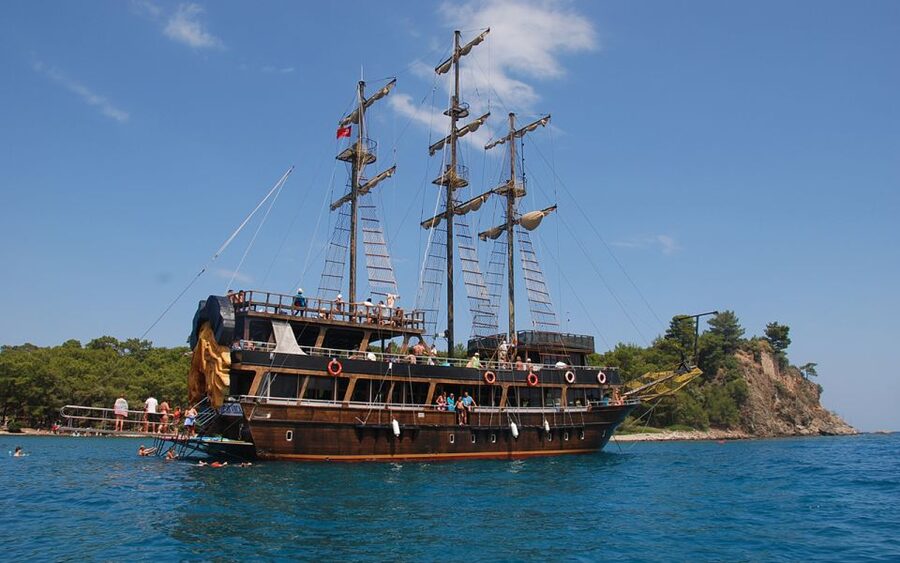 Alanya Pirate Boat Trip with Lunch, Swimming & Foam Party - Leaving Alanya Harbor beside the Red Tower