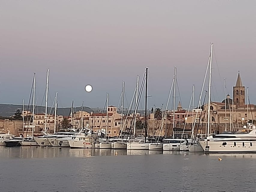 Alghero catamaran sunset tour Alghero - Sailing beside Alghero’s old walls