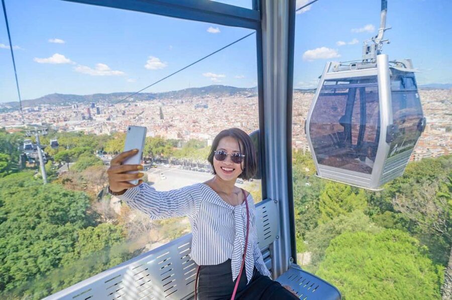 Barcelona: E-Bike Tour with Montjuic Cable Car & Boat Ride - Montjuïc Cable Car, castle, and the city below