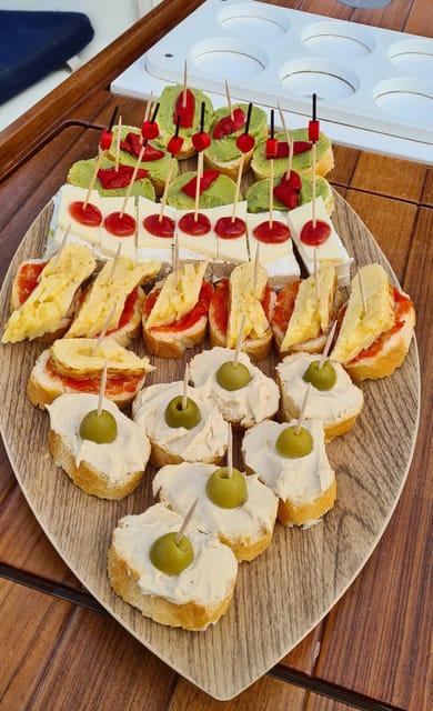 Barcelona: Sailing Tour with Spanish Tapas and Drinks - The first stretch along Barcelona’s shoreline