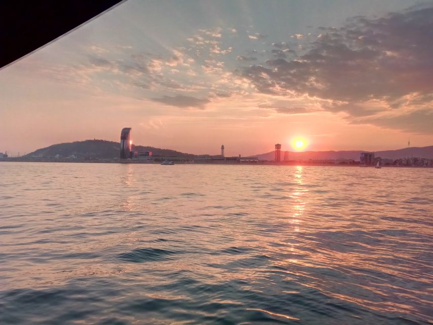Barcelona: Sunset Sailing Tour with Open Bar & Snacks - Leaving Port Olímpic with the golden fish in view