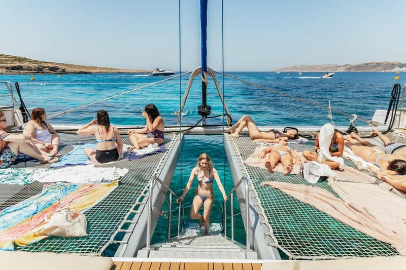 Malta: Blue Lagoon, Beaches & Bays Trip by Catamaran - Sunbeds, nets, and the race for the best place