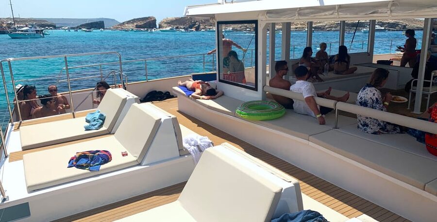 Malta: Blue Lagoon Evening Catamaran Cruise - Crystal Lagoon and its steep cliffs