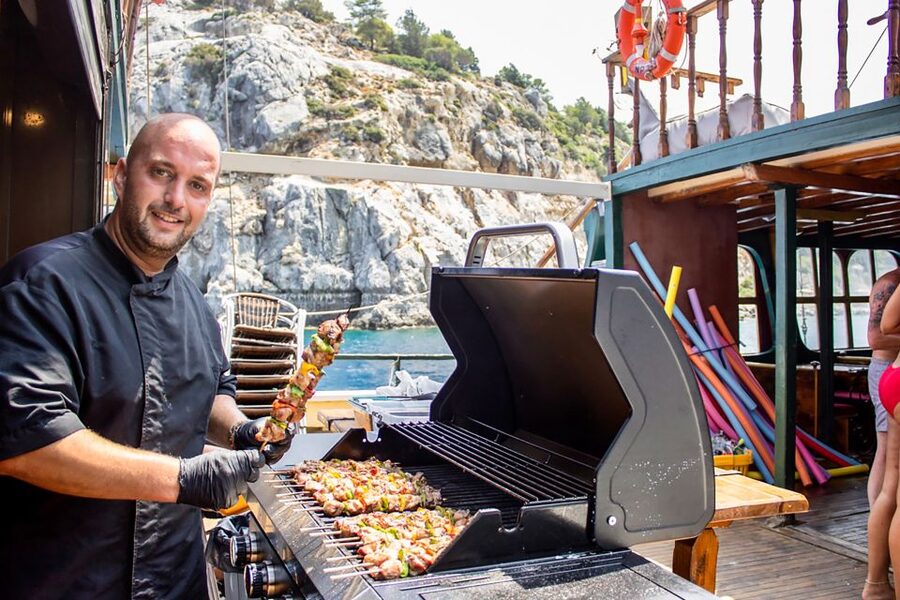 Rhodes: Sunset Cruise with Greek BBQ and Unlimited Drinks - The western sunset near Rhodes Town