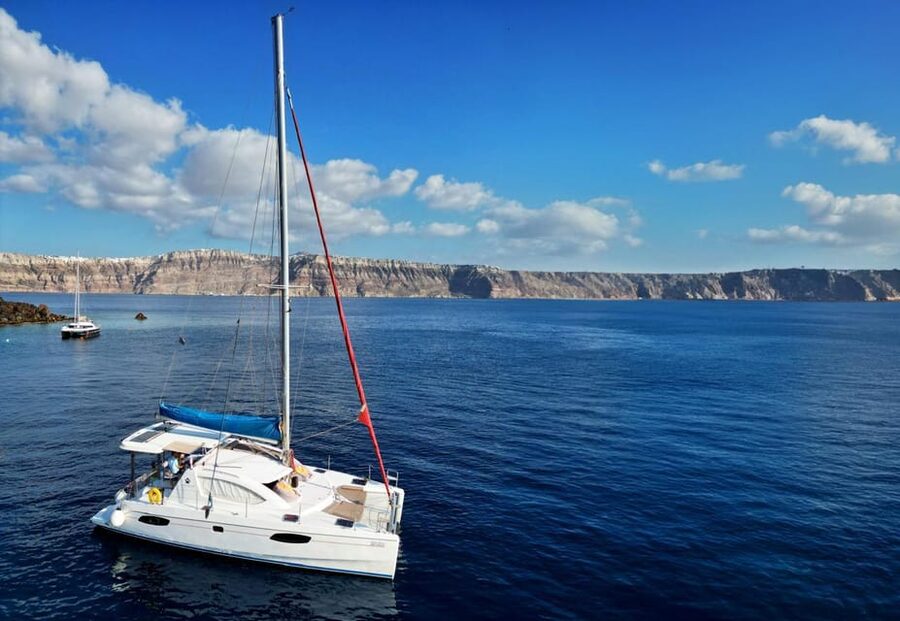 Santorini: Catamaran Cruise with Greek BBQ and Drinks - White Beach, sea caves, and the Akrotiri coast