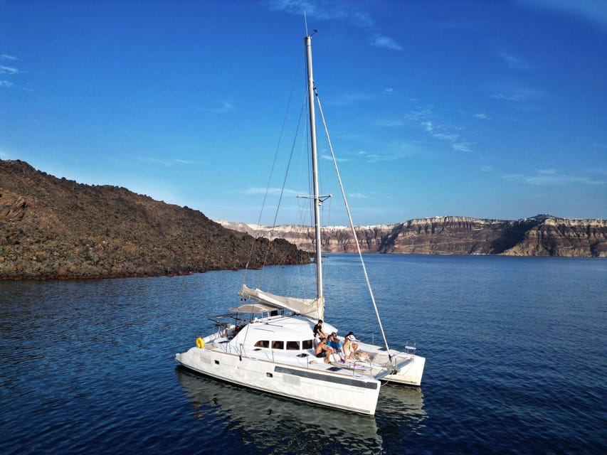 Santorini: Catamaran Cruise with Greek BBQ and Drinks - Red Beach and Santorini’s volcanic colors
