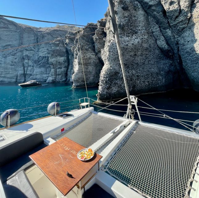 Santorini Catamaran Cruise with Swimming, Meal and Open Bar - Akrotiri Lighthouse and the volcanic Caldera