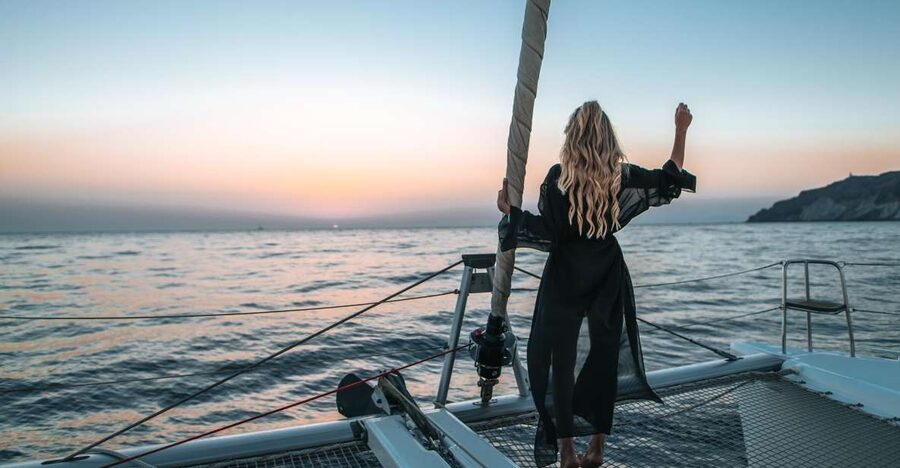 Santorini Catamaran Cruise with Swimming, Meal and Open Bar - The return past Indian Rock and Black Mountain