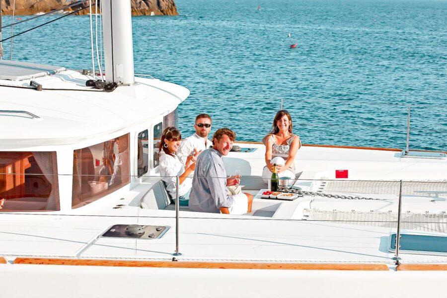 Santorini: Catamaran Tour with BBQ Meal and Unlimited Drinks - White Beach: swimming, sun, and the BBQ table