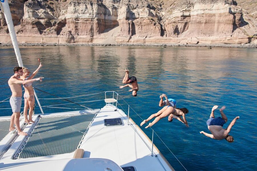 Santorini Gold Catamaran Cruise with Snorkel, BBQ & Open Bar - Leaving Vlychada Marina with a full glass