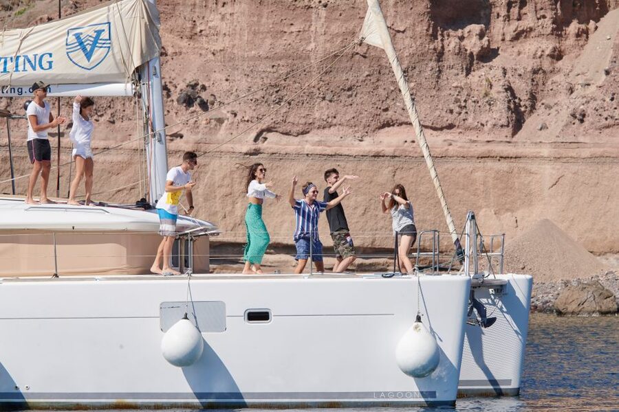 Santorini Gold Catamaran Cruise with Snorkel, BBQ & Open Bar - White Beach, lighthouse, and volcanic rock