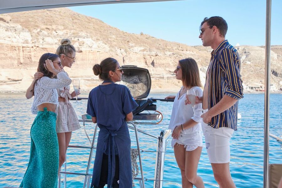 Santorini Gold Catamaran Cruise with Snorkel, BBQ & Open Bar - Sunset timing and seasonal comfort