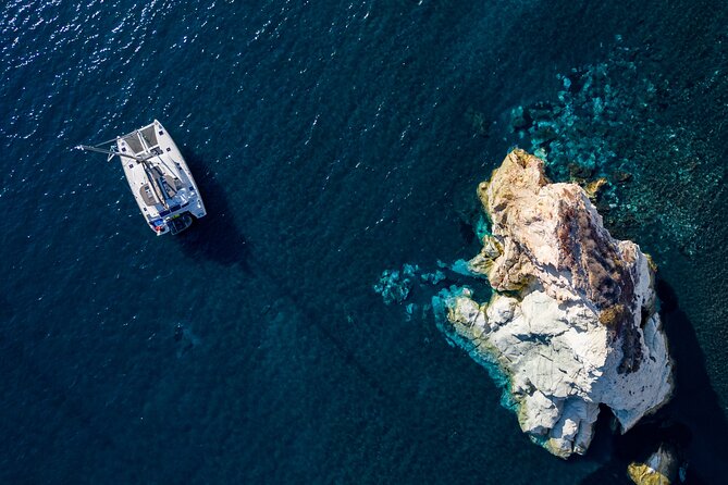 Santorini Platinum Catamaran Cruise with Meal, BBQ and Open Bar - Leaving Vlichada for Santorini’s volcanic coast