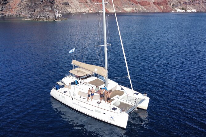 Santorini Platinum Catamaran Cruise with Meal, BBQ and Open Bar - The Akrotiri lighthouse and the volcanic coast