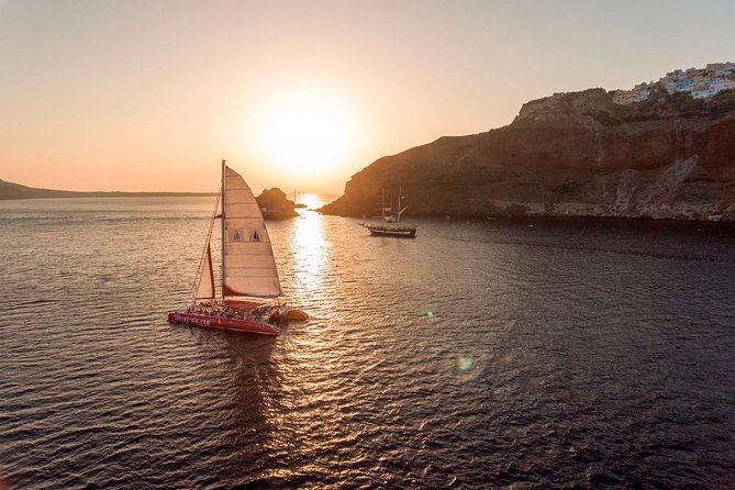 Sunset Sailing Catamaran Cruise in Santorini with BBQ and Drinks - Pickup from your hotel and departure from the port